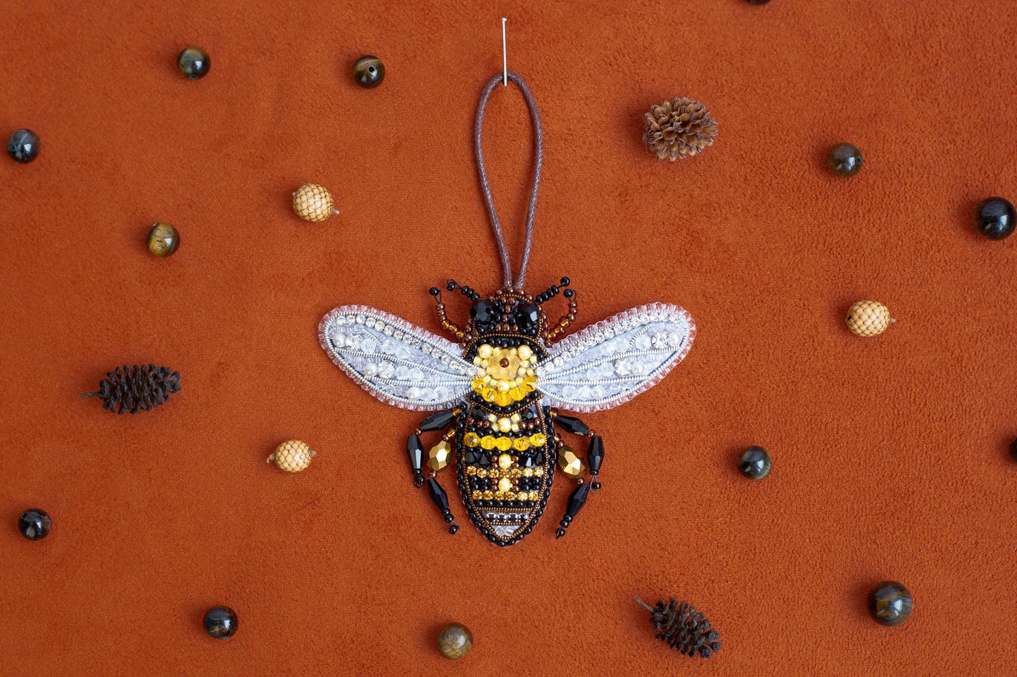 a beaded bee ornament hanging from a string