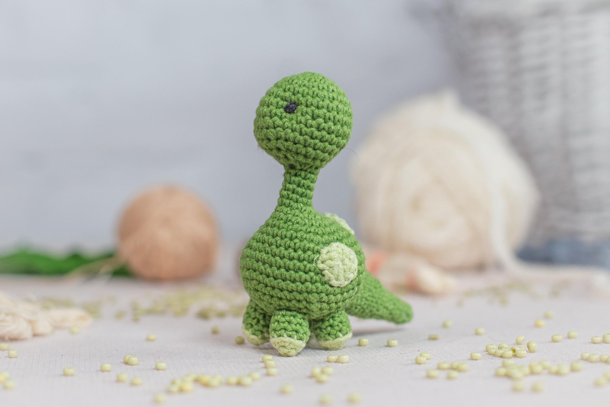 a green crocheted toy sitting on top of a table