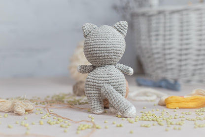 a crocheted teddy bear sitting on top of a table
