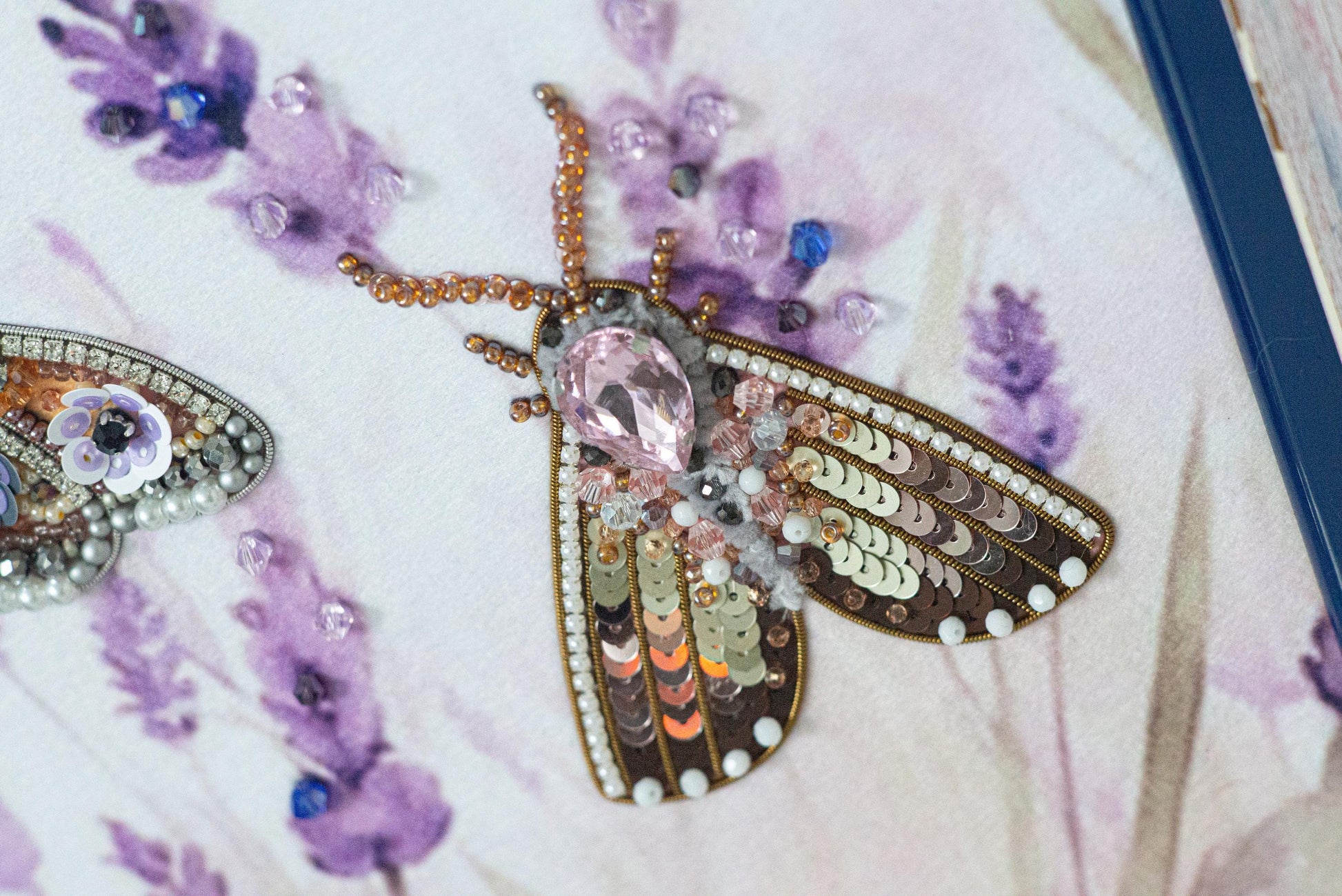 a close up of two brooches on a table