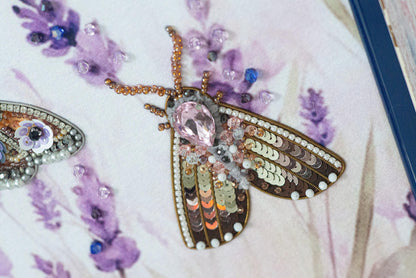 a close up of two brooches on a table