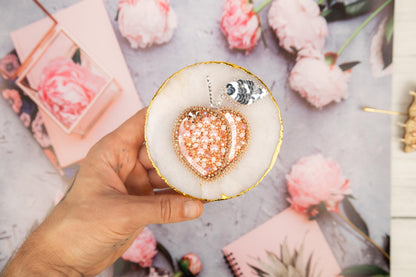 a person holding a cupcake with a heart on it
