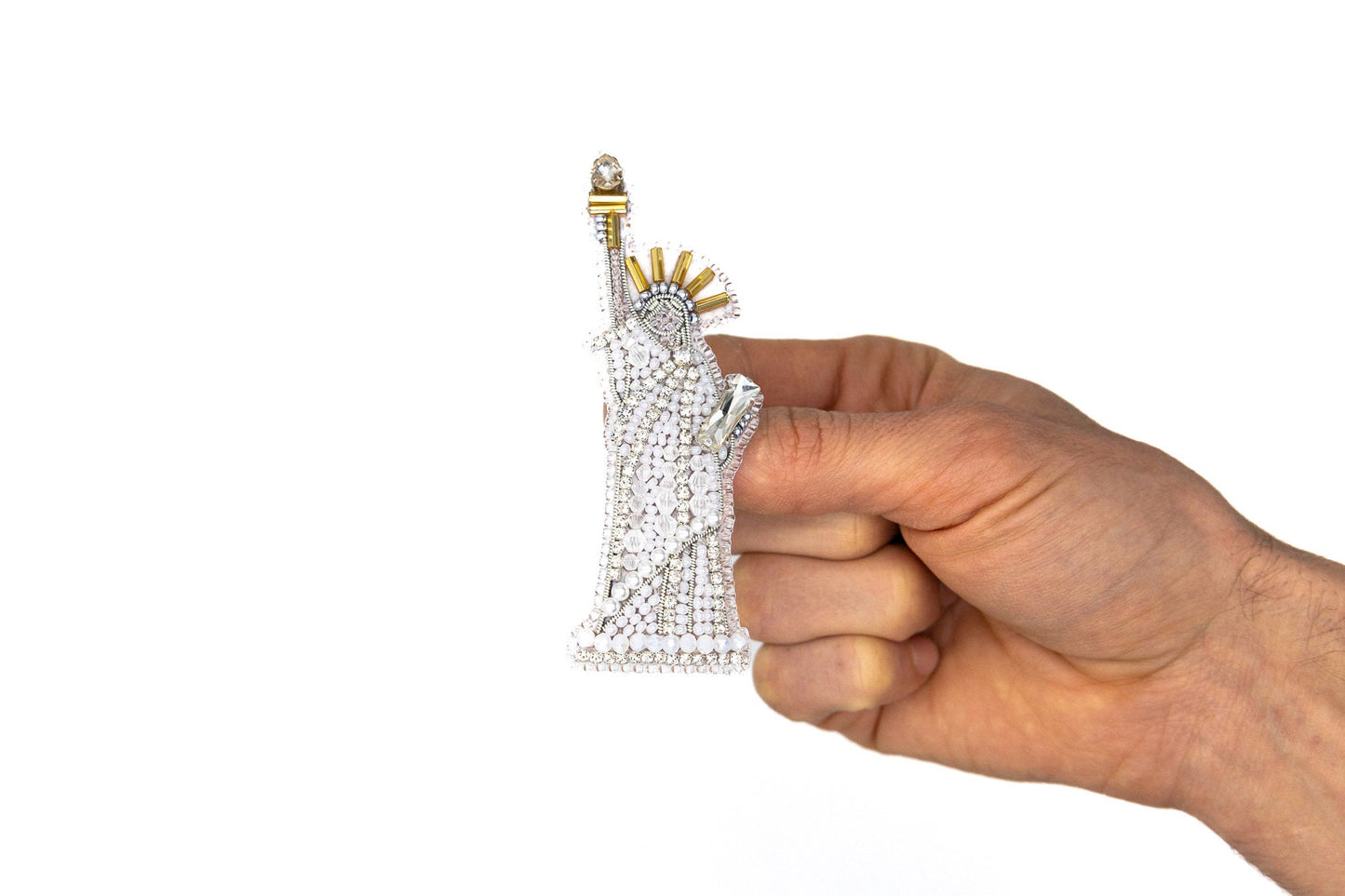 a hand holding a piece of diamond jewelry