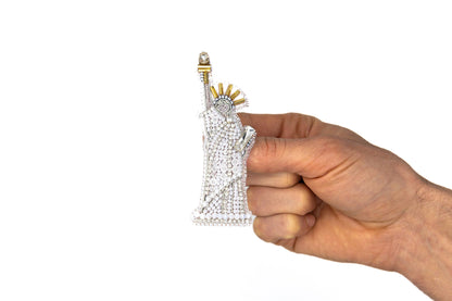 a hand holding a piece of diamond jewelry