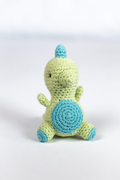 a crocheted stuffed animal sitting on a white surface