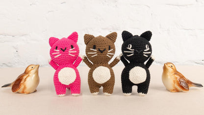 a group of small crocheted animals standing next to each other