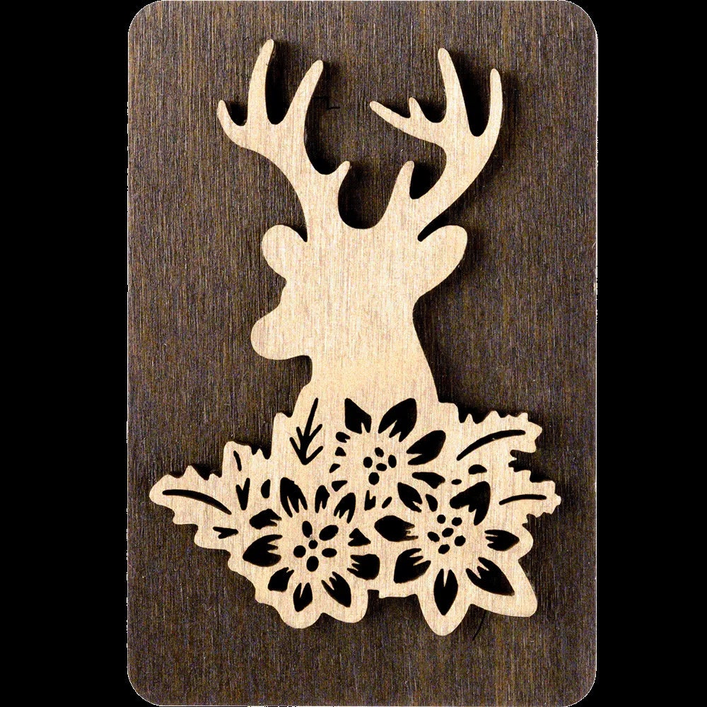 a wooden cutout of a deer with flowers