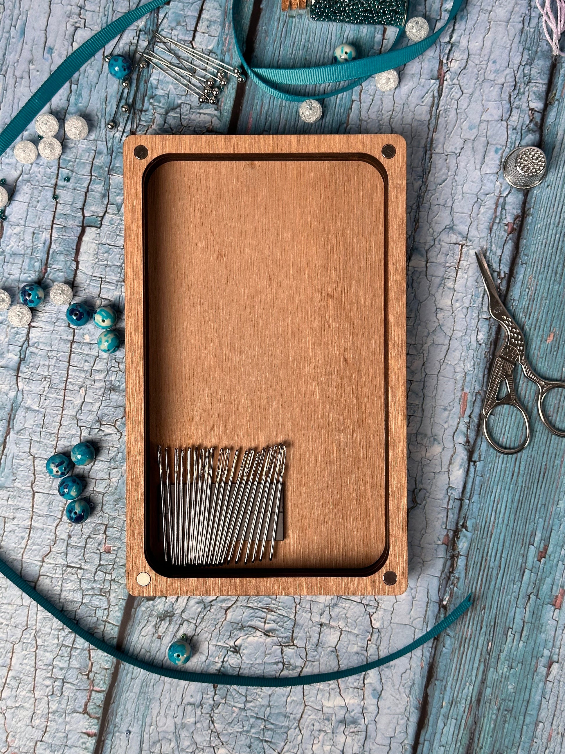 a wooden box with a pair of scissors inside of it