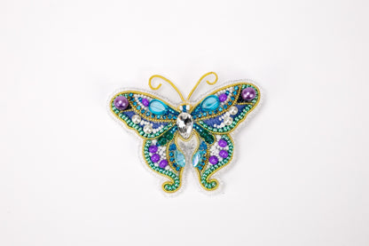 a brooch with a butterfly design on it