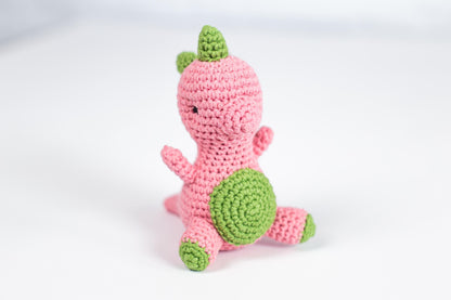 a crocheted pink and green stuffed animal