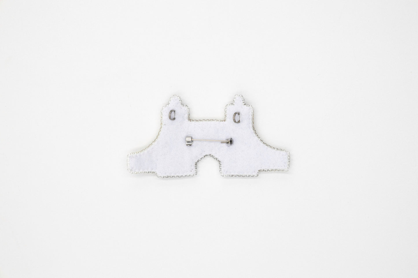 a white piece of cloth with a pair of scissors on it