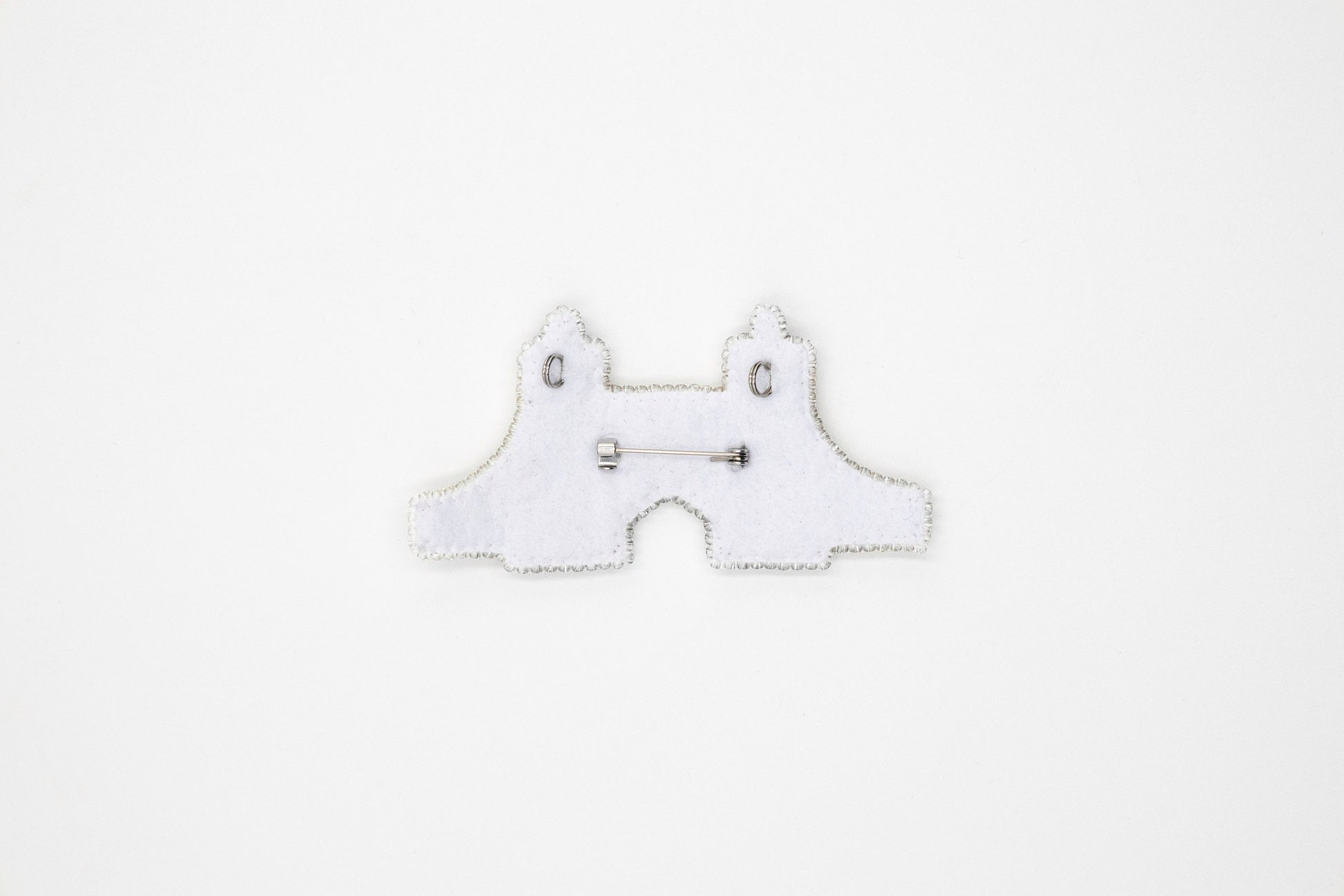 a white piece of cloth with a pair of scissors on it