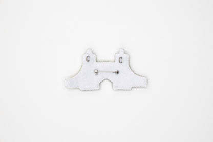 a white piece of cloth with a pair of scissors on it