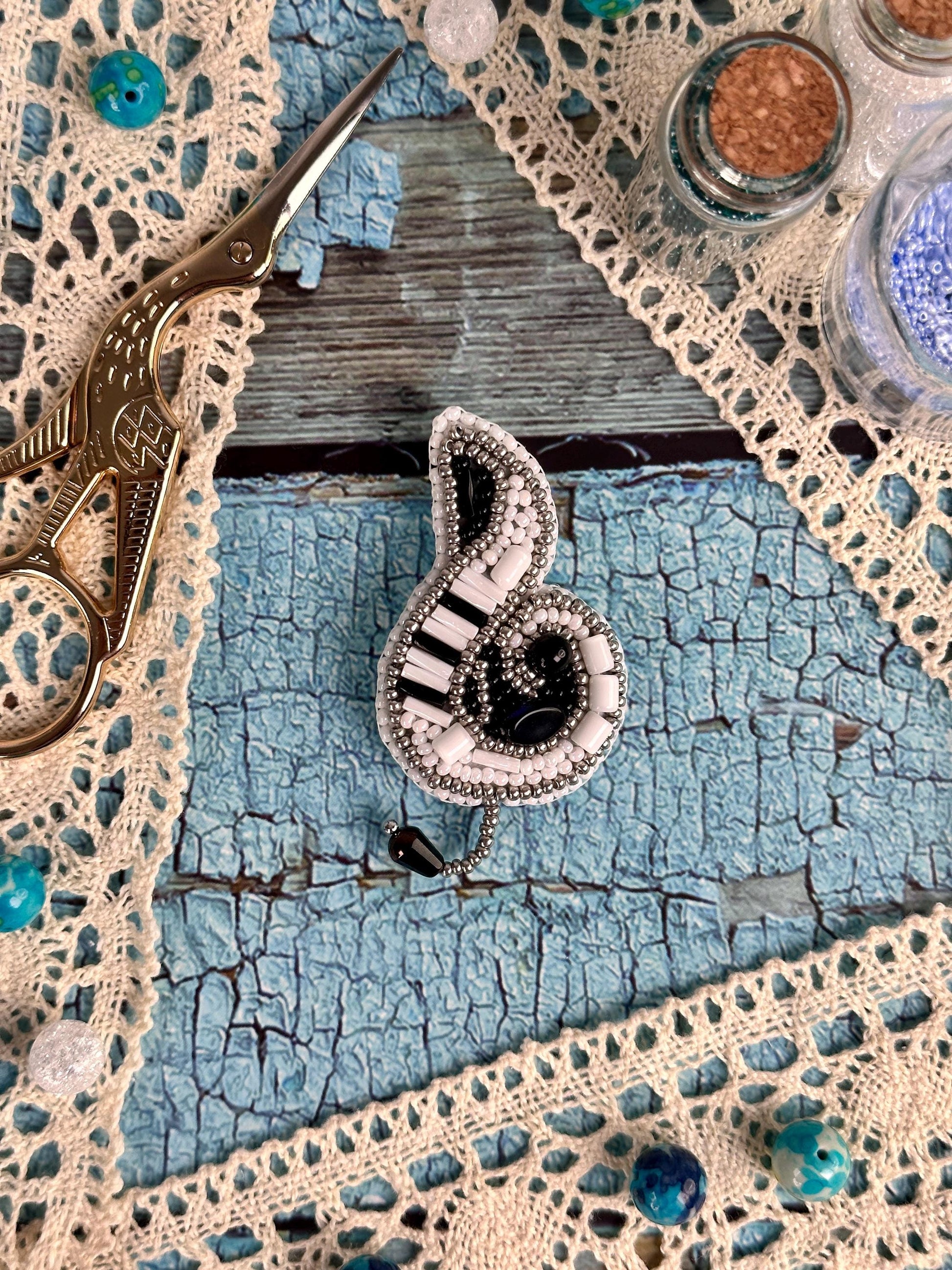 a pair of scissors sitting on top of a doily