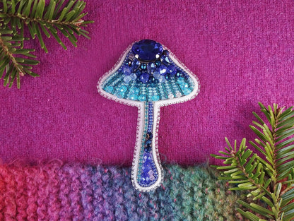 a knitted object with a blue mushroom on it