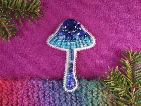 a knitted object with a blue mushroom on it