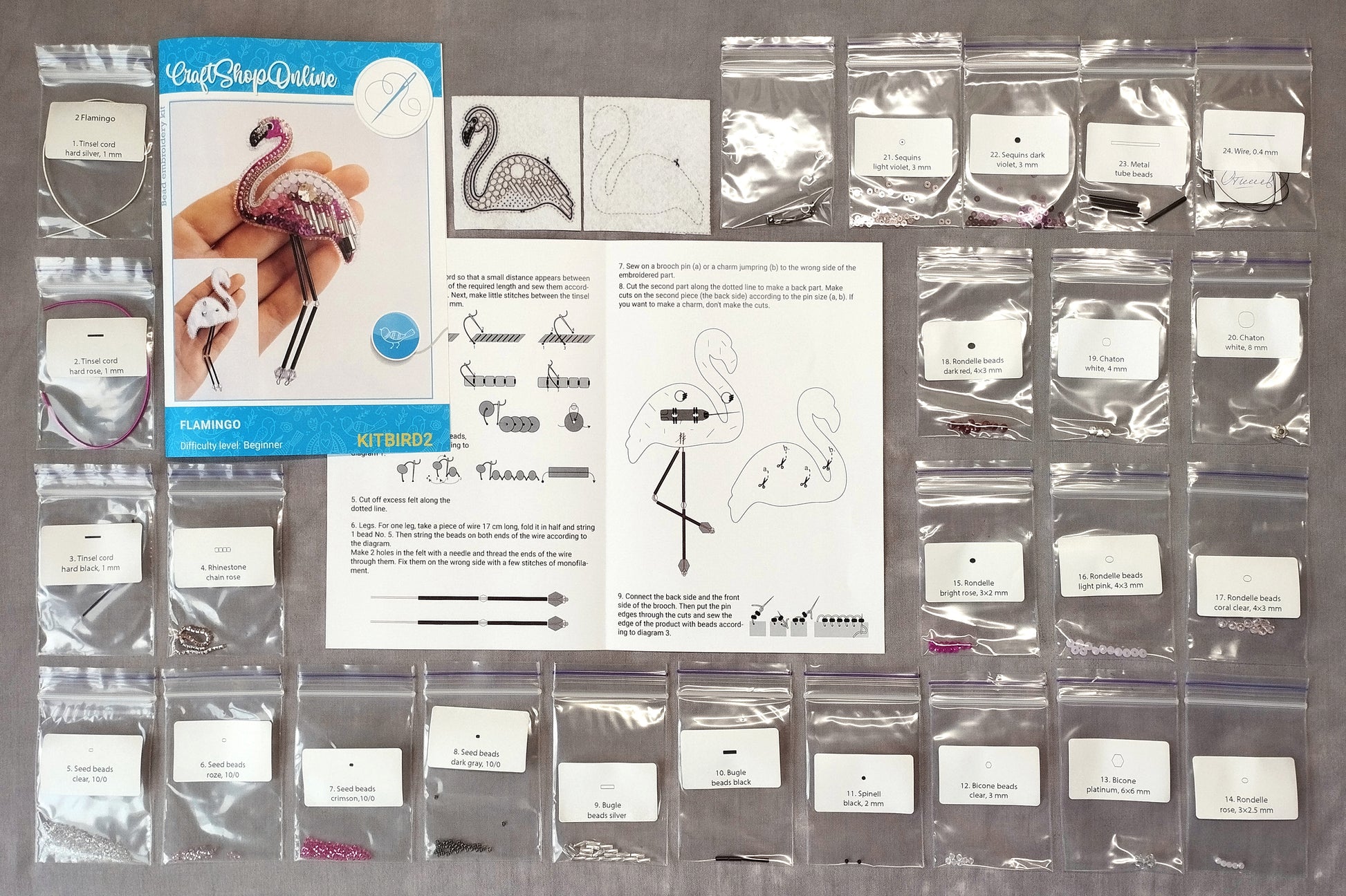 various craft supplies, including a kit labeled "KITB2" and a book titled "Craft Shop Online", as well as several packages of beads and other materials.