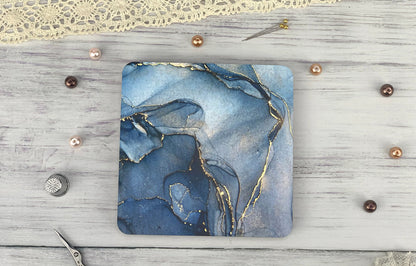 a square coaster with a blue and gold design