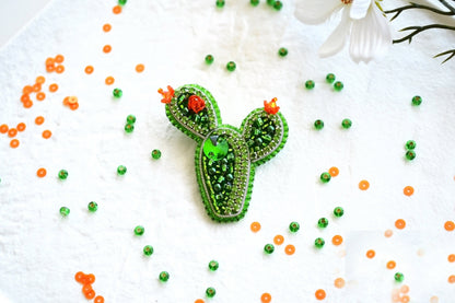a cactus brooch sitting on top of a table