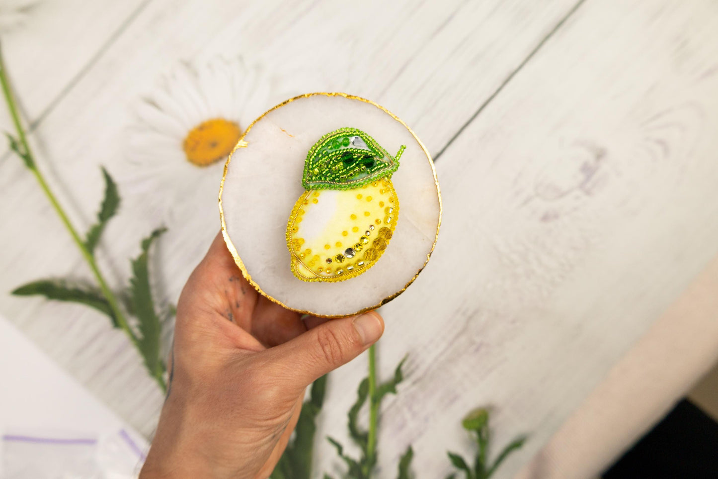 a person holding a small plate with a lemon on it