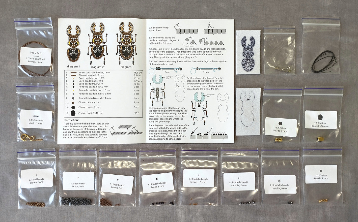 various craft supplies and materials, including bags of beads, a diagram, and instructions, all arranged on a table.