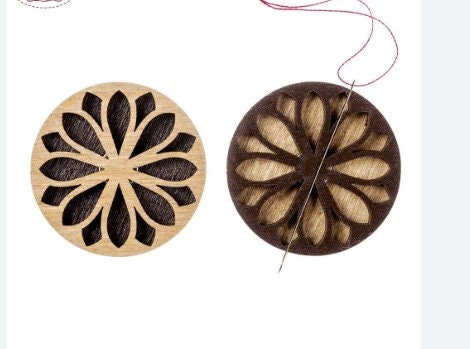 a wooden ornament with a flower design on it
