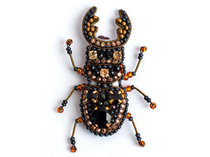 a bug made of beads and beads on a white surface