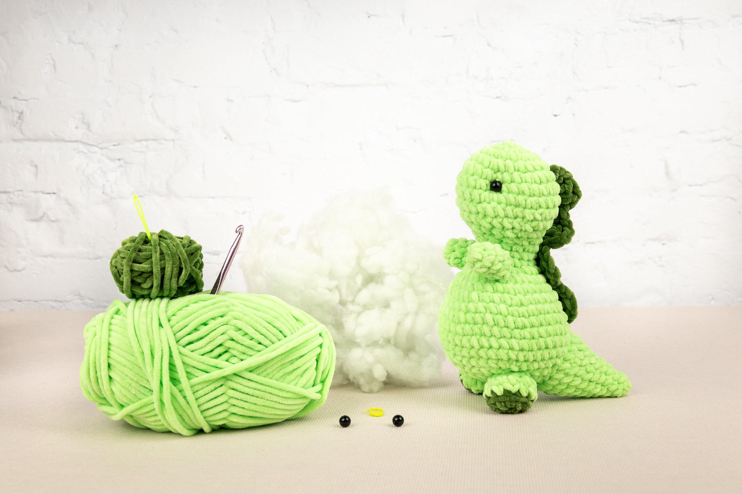 a green ball of yarn next to a green ball of yarn