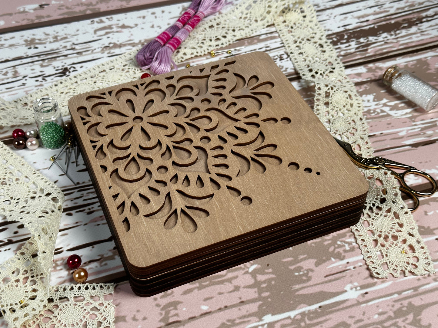 a small wooden box with a flower design on it