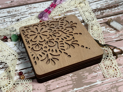 a small wooden box with a flower design on it