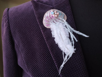 A close-up view of a purple jacket with a decorative brooch or pin attached to the lapel.