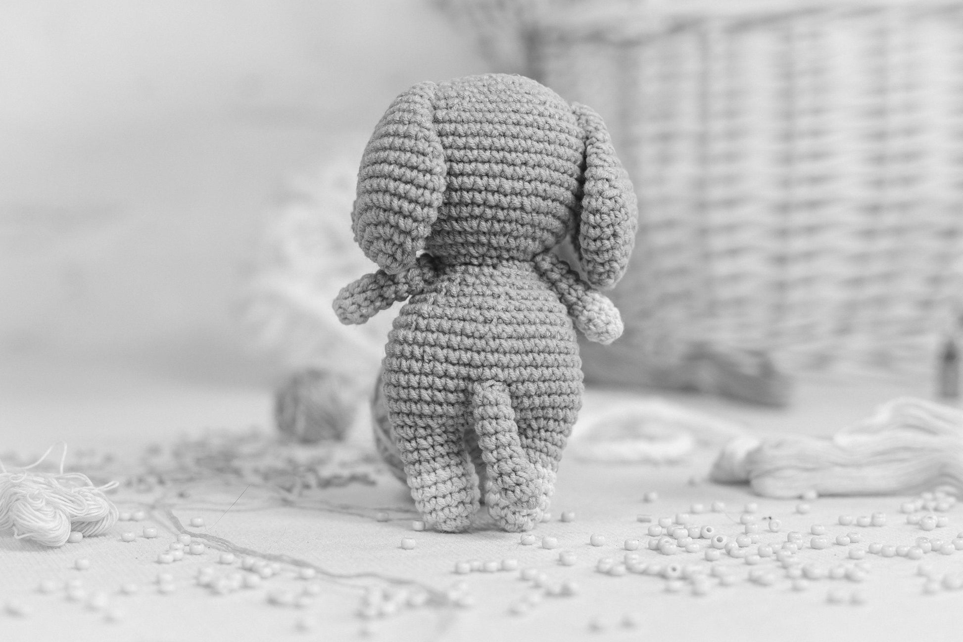 a small crocheted elephant sitting on top of a table