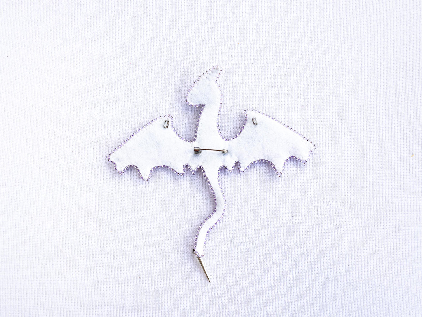 a white piece of fabric with a bat on it