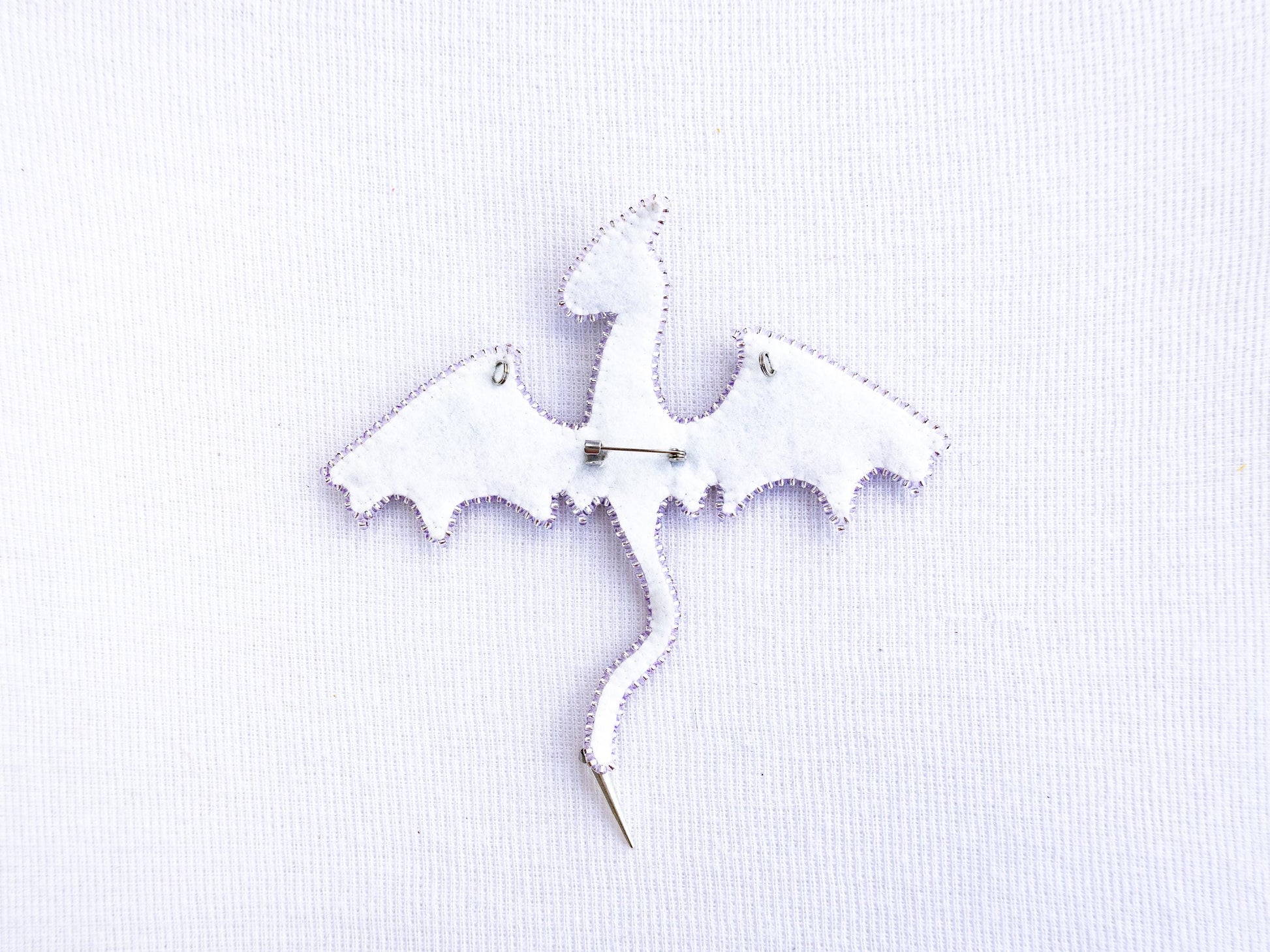a white piece of fabric with a bat on it