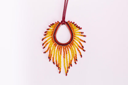 a beaded necklace is hanging on a cord