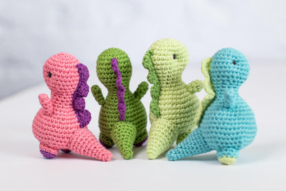 a group of crocheted toy animals sitting next to each other