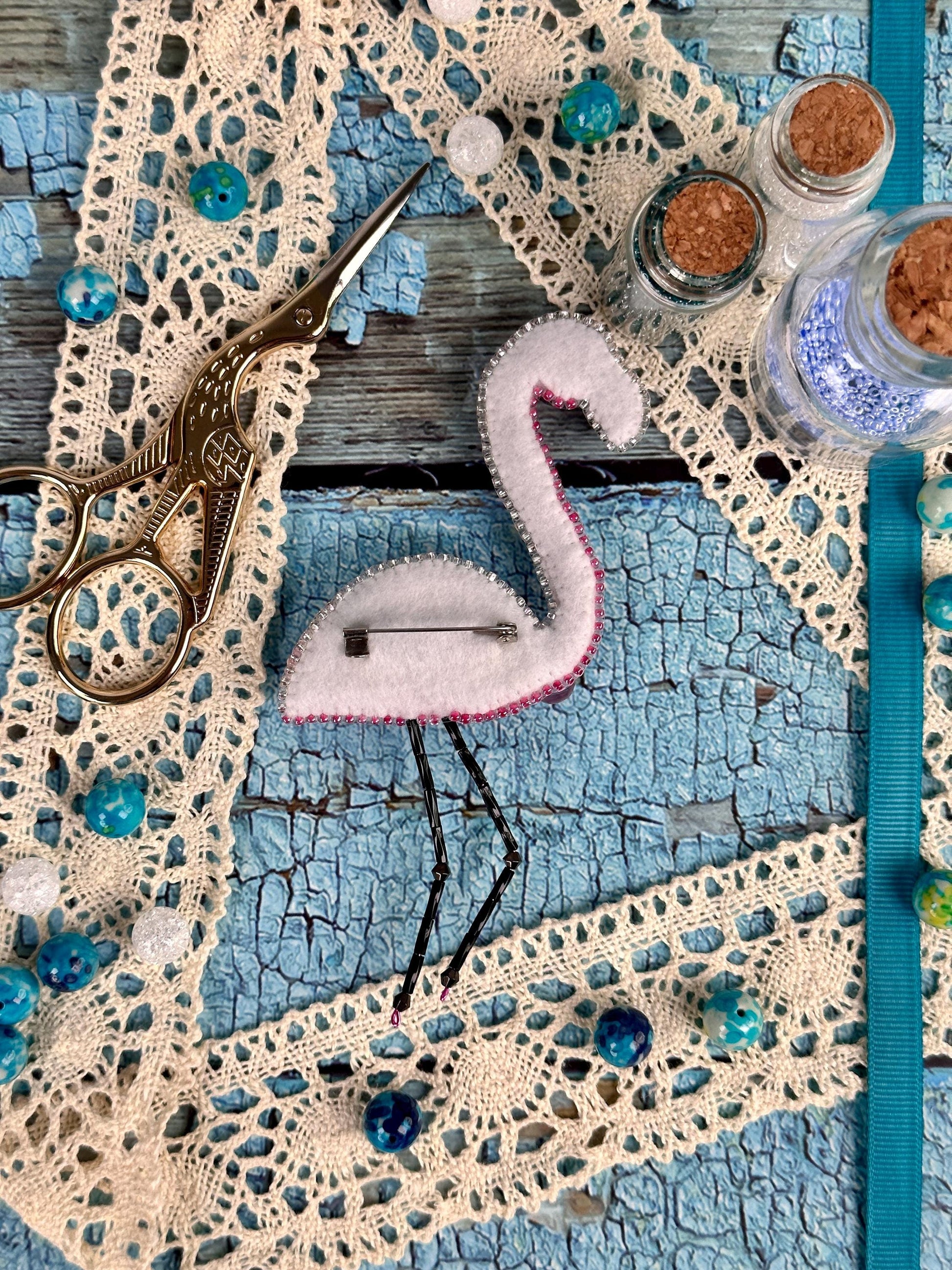 a pair of scissors sitting on top of a piece of lace