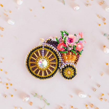 a close up of a brooch with flowers on it