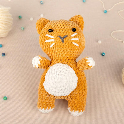 a crocheted cat sitting on top of a table