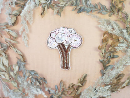 a brooch with a bouquet of flowers on it
