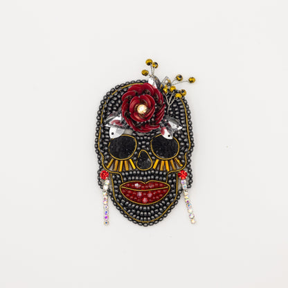 a black and red mask with a flower on it