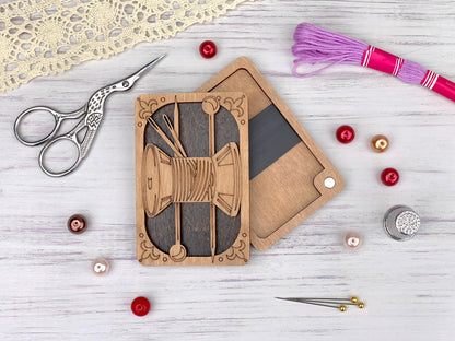 a pair of scissors, a pair of scissors, a pair of thread, and