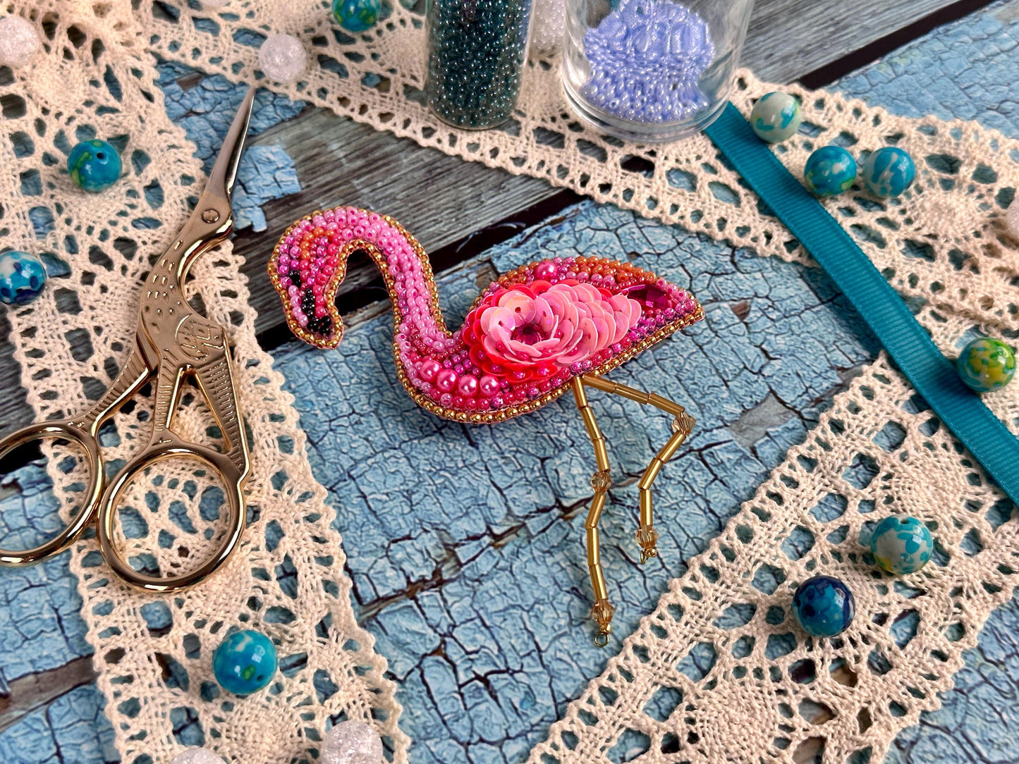 a pink flamingo keychain sitting on top of a table