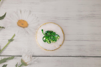 a plate with a green broccoli on it next to a flower