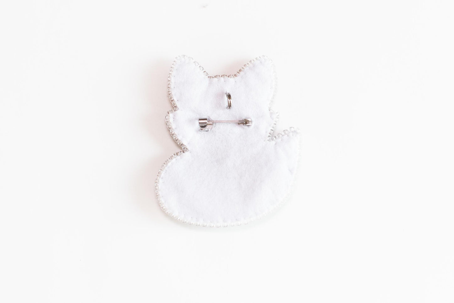 a pair of scissors sitting on top of a white piece of cloth