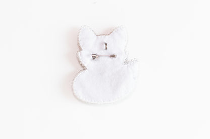 a pair of scissors sitting on top of a white piece of cloth