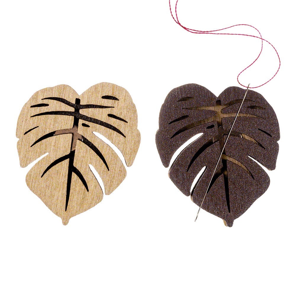 a wooden cutout of a heart and a wooden cutout of a leaf