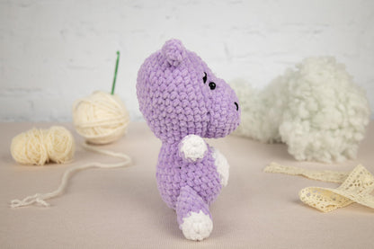 a crocheted stuffed animal next to a ball of yarn