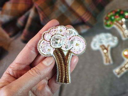 a person holding a brooch in their hand