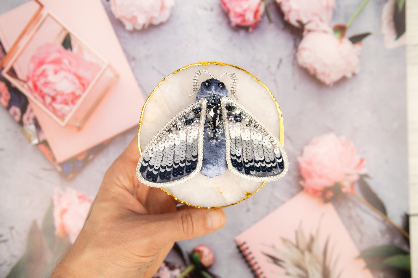 a hand holding a paper cut out of a butterfly